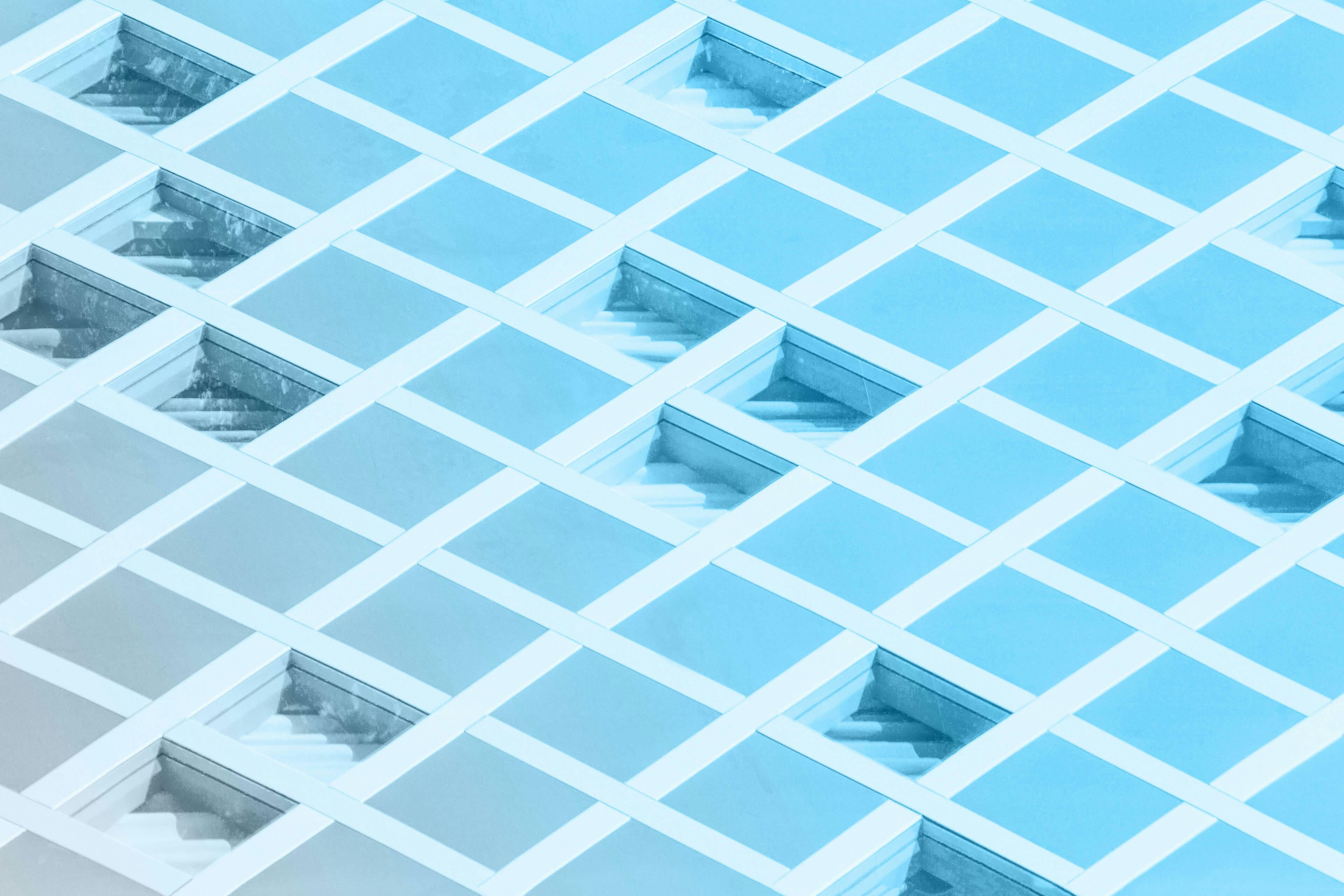 3-d rendering of a flat, checkerboard surface with random indents in select squares.